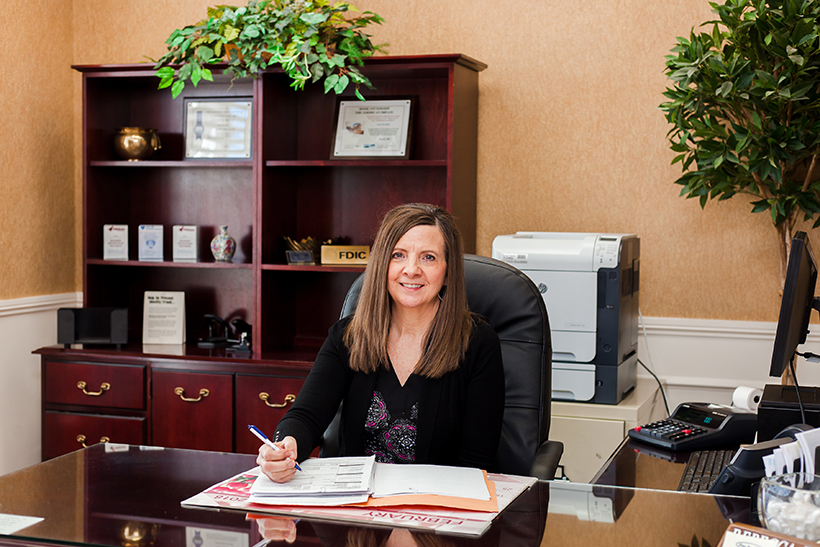 new era bank employee at desk